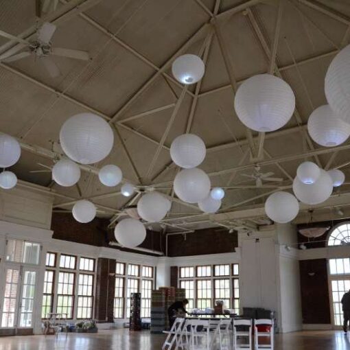 Paper Lanterns hanging inside The Prospect Park Picnic House for a wedding.
