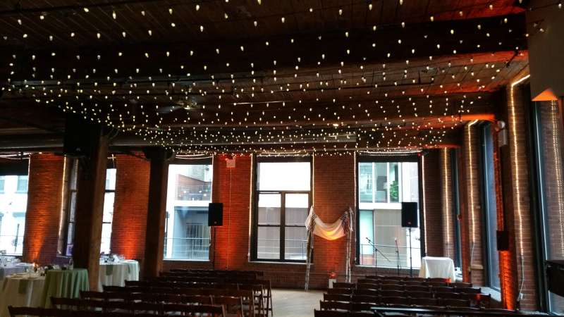 A canopy of C7 LED String Lights over the dance floor at The Dumbo Loft. Also Up-Lights around the perimeter of the room.