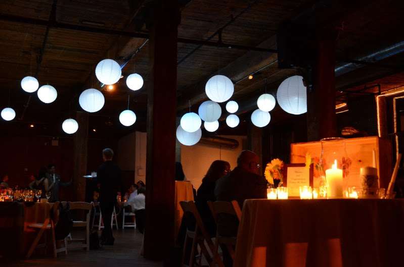 Paper Lanterns with decorative LED lights inside hanging over dance floor for wedding at the Dumbo Loft.