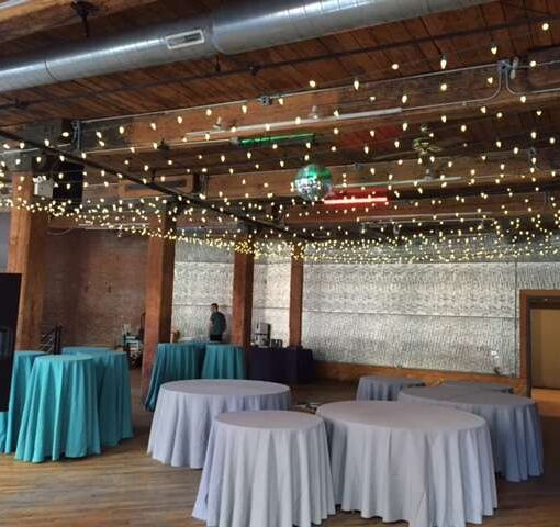 A Canopy of C7 LED String Lights hanging between the center columns at The Dumbo Loft.