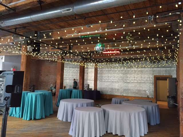 A Canopy of C7 LED String Lights hanging between the center columns at The Dumbo Loft.