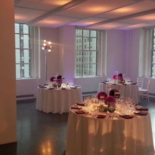 Setup lavender wireless LED Up-Lights around the inside perimeter walls for a wedding at 620 Loft and Garden. Also, set up pin spots on the table centerpieces for a wedding at 620 Loft & Garden.