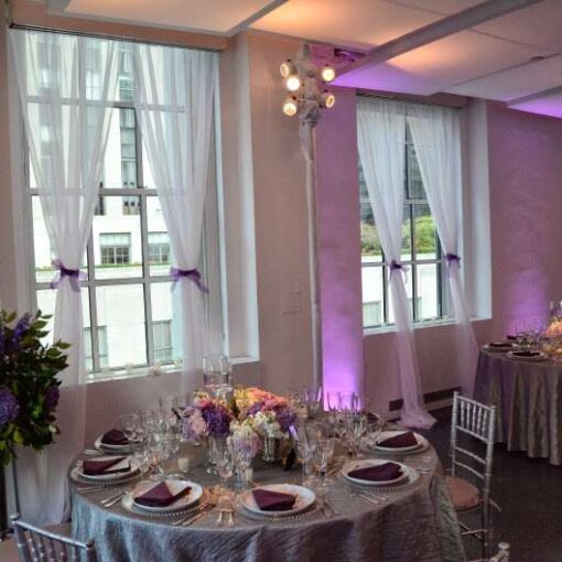 Setup lavender wireless LED Up-Lights around the inside perimeter walls for a wedding at 620 Loft and Garden. Also, set up pin spots on the table centerpieces for a wedding at 620 Loft & Garden.