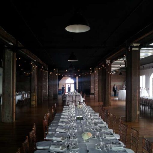 Universal Light and Sound setup string lights (Bistro Lights) over the dance floor for a beautiful summer wedding at The Liberty Warehouse.