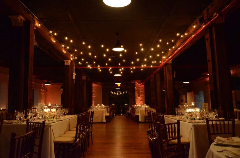 String Lights hanging over the dance floor in the Harbor Room on the 1st Floor at The Liberty Warehouse. Also, Up-Lights along the perimeter walls. 