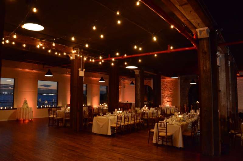 String Lights hanging over the dance floor in the Harbor Room on the 1st Floor at The Liberty Warehouse. Also, Up-Lights along the perimeter walls. 
