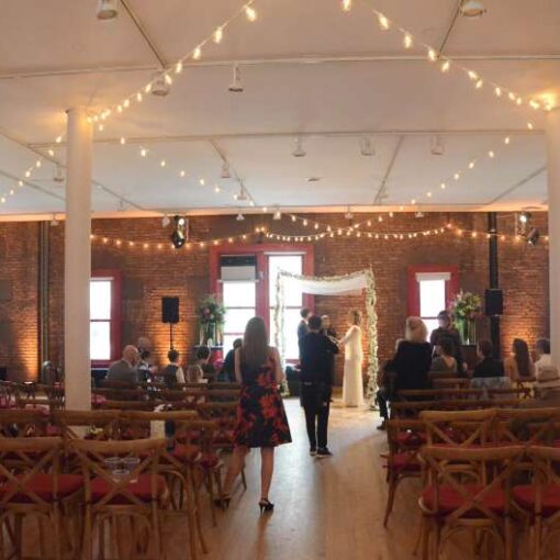 String Lights w/ Round G50 Bulbs hanging overhead for a wedding at The New York City Fire Museum.  Also, Up-Lights setup around the inside perimeter walls of the reception room at The New York City Fire Museum.