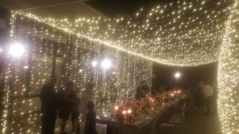 A Tunnel of LED Lights hanging above the dinner table for a micro wedding at The Clubhouse of Lake Success.