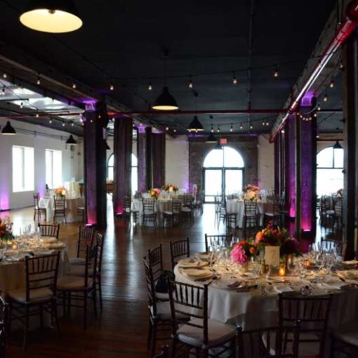 Pin Spots for wedding reception in Harbor Room at Liberty Warehouse in Red Hook (Brooklyn, NY). Also, Wireless Battery Powered LED Up-Lights. In addition, Cafe Lights/String Lights hanging over the dance floor.