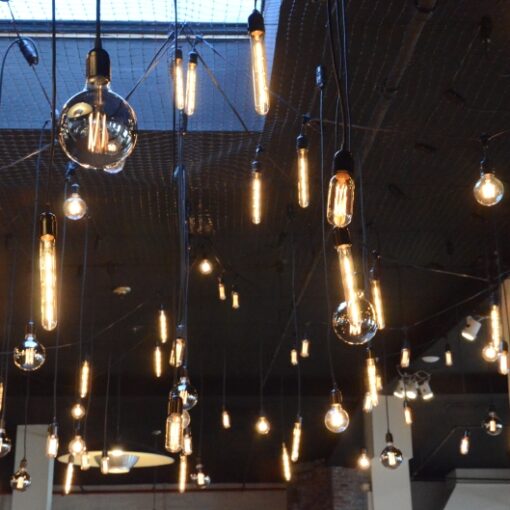 Pendant Lamps randomly hanging with various Antique Bulbs over dance floor at The Liberty Warehouse.