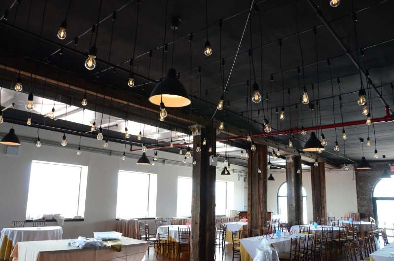 Multiple individual Pendant Lamps with vintage antique Edison bulbs hanging over the dance floor at The Liberty Warehouse.