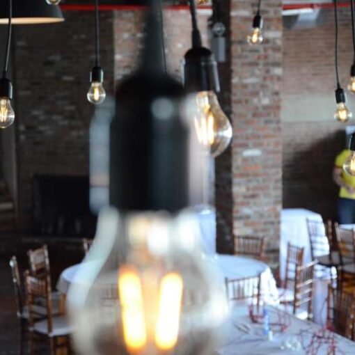 Multiple individual Pendant Lamps with vintage antique Edison bulbs hanging over the dance floor at The Liberty Warehouse.