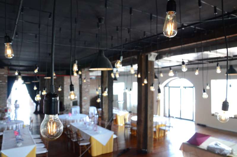 Multiple individual Pendant Lamps with vintage antique Edison bulbs hanging over the dance floor at The Liberty Warehouse.