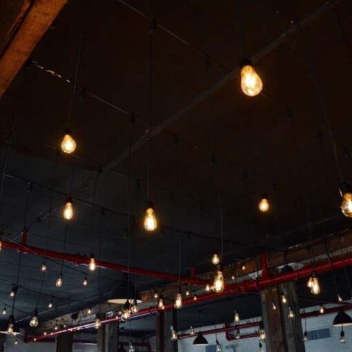 Pendant lamps with vintage/antique style Edison Bulbs hanging over the dance dance floor at The Liberty Warehouse