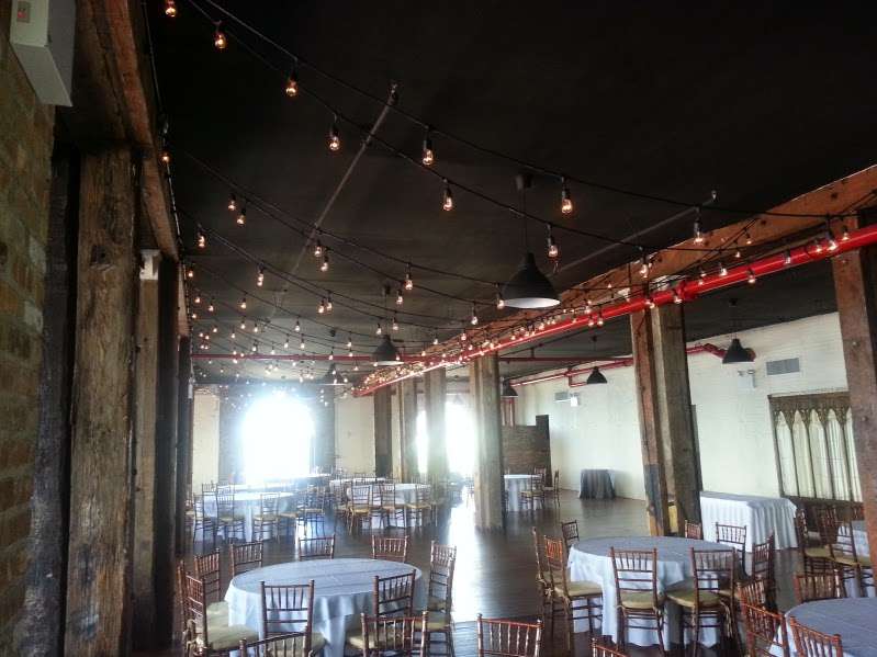 Bistro Lights hanging above the full length of the reception room between the center columns at The Liberty Warehouse.
