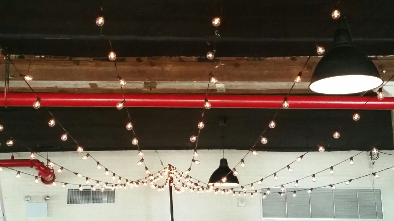 String Lights hanging in a triangular pattern over the dance floor at The Liberty Warehouse in Brooklyn, NY.