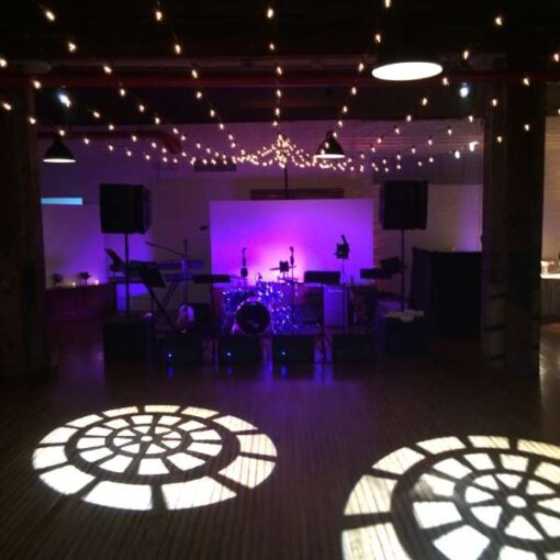String Lights hanging in a triangular pattern over the dance floor at The Liberty Warehouse in Brooklyn, NY.