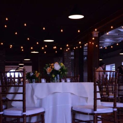 String Lights hanging above the dance floor for a wedding reception in the Harbor Room at The Liberty Warehouse.