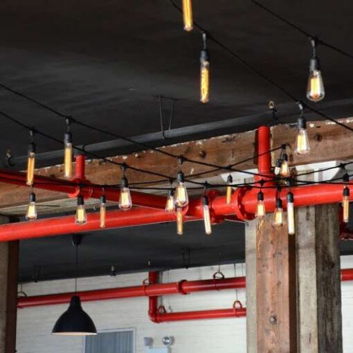 String Lights with antique Edison Bulbs hanging over the dance floor in The Harbor Room at The Liberty Warehouse.