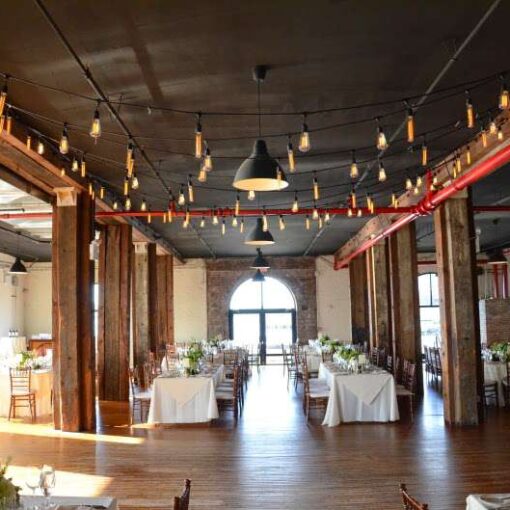 String Lights with antique Edison Bulbs hanging over the dance floor in The Harbor Room at The Liberty Warehouse.