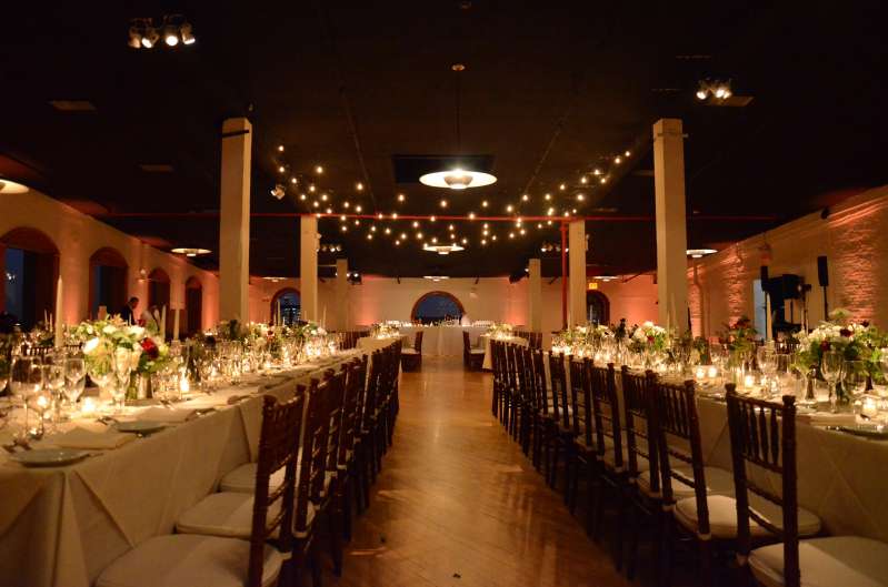 String lights are hanging above the dance floor in the Governor's Room on the 2nd floor at The Liberty Warehouse. Also, Table Pin-spots for the centerpiece at each table and both bars at each end of the room. In addition, Up-Lights along the perimeter walls.