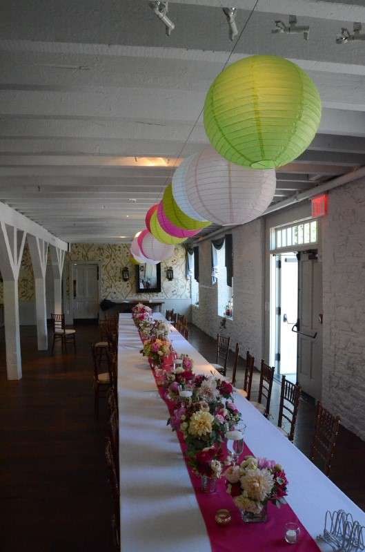 40 Paper Lanterns in various colors hanging in the main room over two rows of banquet tables in The Stone Mill.