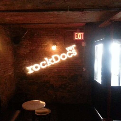 Two custom gobos are hanging on a wall for the exclusive “The Best of VH1 rockDocs” party at The Wythe Hotel.