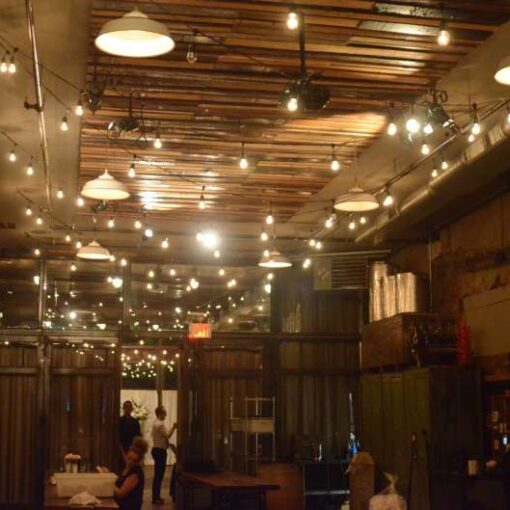 150ft of string lights with S14 bulbs hanging in a zigzagging pattern in the Harvest Room at The Brooklyn Winery.