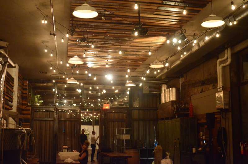 150ft of string lights with S14 bulbs hanging in a zigzagging pattern in the Harvest Room at The Brooklyn Winery.