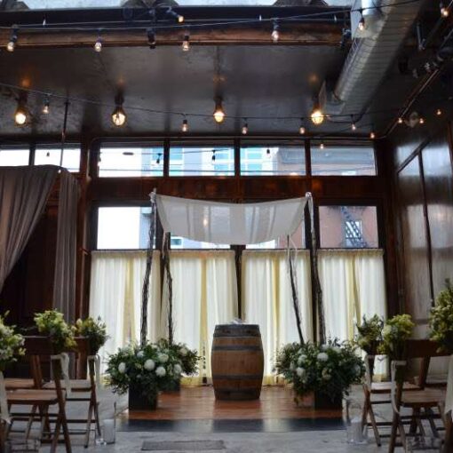 150ft of String Lights hanging in a zigzagging pattern overhead for a wedding in The Atrium at The Brooklyn Winery.
