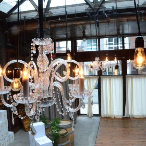 Pendant Lamps along with Chrystal Chandeliers hanging overhead in the Atrium at The Brooklyn Winery.