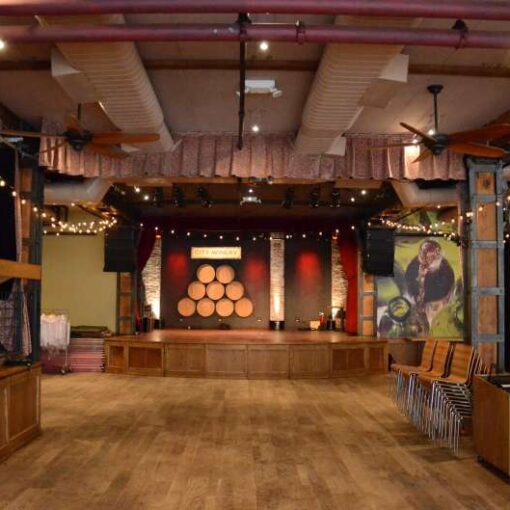 String Lights hanging in V-shape patterns from the left and right side of the stage at The City Winery.