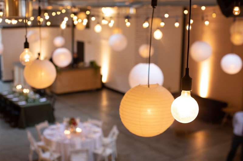 String Lights with Paper Lanterns hanging in a zigzagging pattern above the main floor for a wedding at Dobbin St.