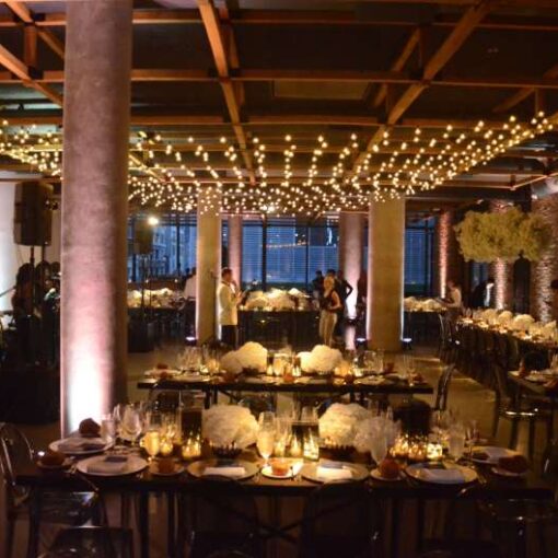 A canopy of String Lights hanging above The Great Room inside the Second Floor at The Eventi Hotel. Also, String Lights hanging vertically as a backdrop again a wall in The Great Room (East). Finally, Up-Lights and Pin-Spots in both The Great Room East and West at The Second Floor inside the Eventi Hotel.