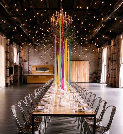 Warm White String Lights hanging overhead vertically as multiple six-foot pendants for Love Union at The Green Building.