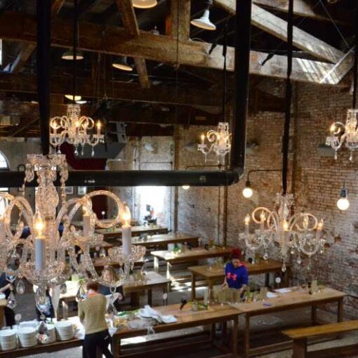 Chrystal Chandelier hanging at random heights and spacing above the main floor for a wedding at The Houston Hall.