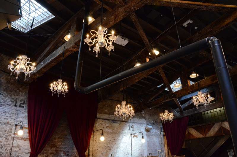 Chrystal Chandelier hanging at random heights and spacing above the main floor for a wedding at The Houston Hall.