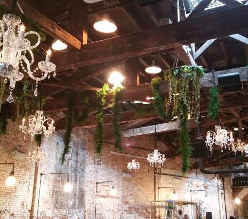 Venetian Crystal Chandeliers hanging at random heights and spacing above the main floor for a wedding at The Houston Hall.
