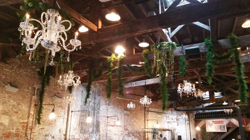 Venetian Crystal Chandeliers hanging at random heights and spacing above the main floor for a wedding at The Houston Hall.