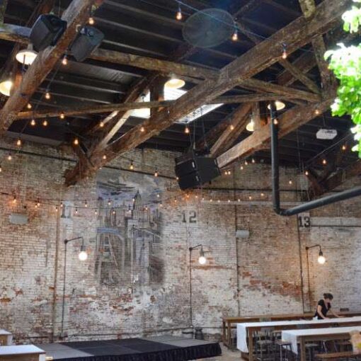 Warm White String Lights hanging overhead in a zigzagging pattern for a wedding at The Houston Hall.