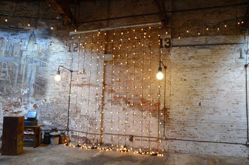 Vertical Curtain of String Lights hanging against the rear wall for a wedding at The Houston Hall.
