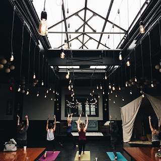 Pendant Lamps hanging under the skylight in the main room at 501 Union for opening yoga with at Love Union.