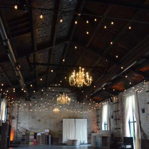String Lights hanging in a zigzag pattern above the majority of the main room inside The Green Building.