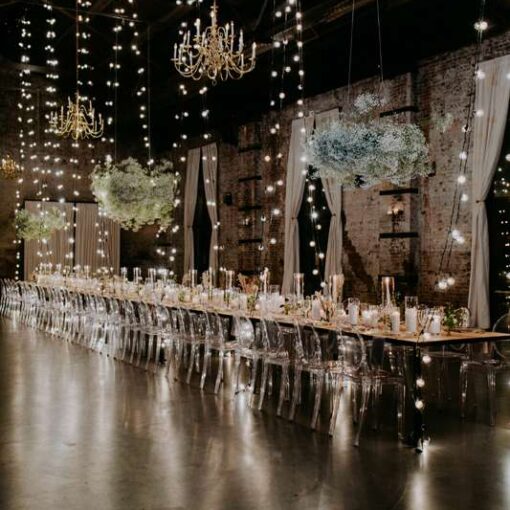 Vertical String Lights hanging from the ceiling peak to the floor below for Jove Meyer's Planners Dinner at Love Union.
