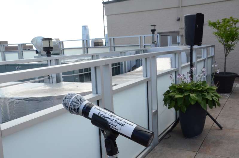 A microphone and speakers for a rooftop ceremony at Tribeca Rooftop.