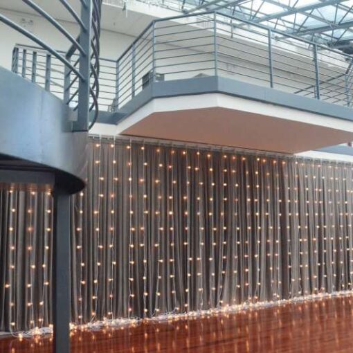 String Lights with round G50 bulbs hanging vertically as a curtain of lights for a wedding at The Tribeca Rooftop.