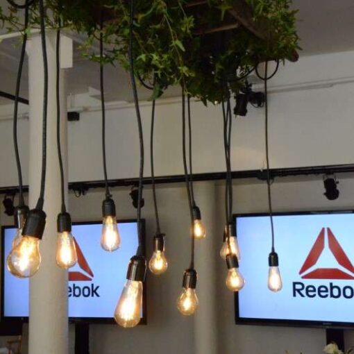 Pendant lamps with Vintage Antique Edison Bulbs hanging overhead for a media event at 91 Horatio for Reebok's "Be More Human Campaign" featuring UFC champion Ronda Rousey.