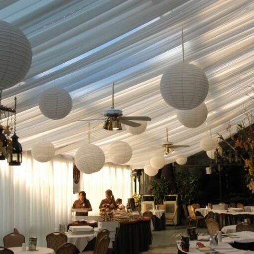 A dreamy food and wine festival with decorative white Paper Lanterns hanging overhead at The Astoria World Manor in Queens, NY.
