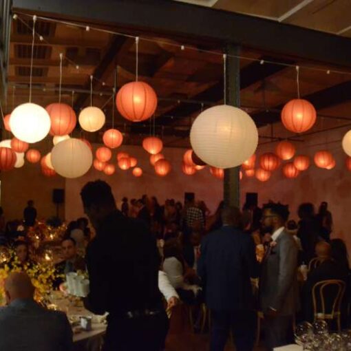 Burgundy and White Paper Lanterns hanging in the main room for a wedding reception at The Bathhouse Studios in New York City.