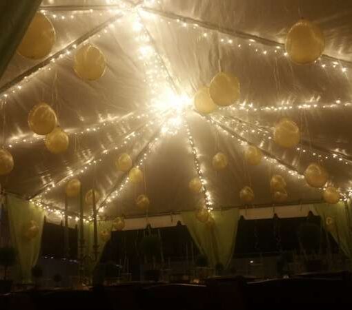 Suspended mini LED String Lights with Warm White Bulbs along a tent frame for a Bat Mitzvah at The Beth Rivkah Elementary School in Brooklyn, NY.